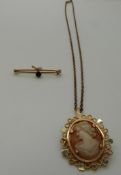 An 18ct gold pendant set with a cameo on a yellow metal chain and a 9ct gold brooch set with