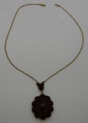 A Victorian pendant set with tiered Bohemian garnets on a yellow metal chain, 12.