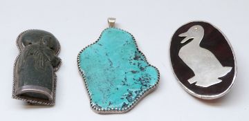 A faux tortoiseshell brooch set with a silver duck to the centre,