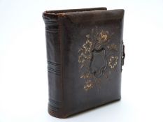 Musical 'Reuge' Carte Visite album with embossed leather cover and brass clasp