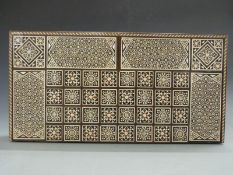 Eastern inlaid games compendium with smaller box housing games and a chess set in box, width 50.