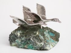 Greek pair of white metal geese in flight on stone base, the swans marked 925 Ilias Lalaounis,