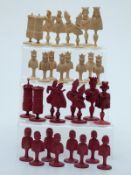 An 18thC French Dieppe bone figural chess set with carved pieces, one side stained red,
