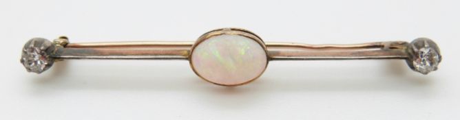 A 9ct gold brooch set with an oval opal cabochon and two old cut diamonds, 3.23g, L5.