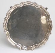 Hallmarked silver salver with piecrust edge raised on four feet, Birmingham 1971 maker John Rose,