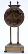 A 19thC brass gravity / mystery clock with visible movement,
