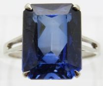 A 9ct white gold ring set with an emerald cut synthetic sapphire,