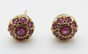 A pair of 9ct gold earrings set with rubies in a cluster