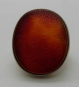 A silver ring set with a carnelian agate panel engraved with script design