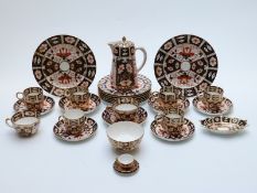 A collection of Royal Crown Derby 2451 tea and coffee ware including a miniature trio
