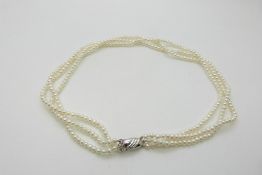 A three strand pearl necklace with 9ct white gold clasp