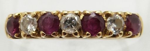 An 18ct gold ring set with alternating rubies and diamonds,