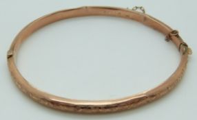 Edwardian 9ct rose gold bangle with engraved foliate decoration, Chester 1907, 5.