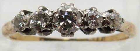An 18ct gold ring set with five graduated diamonds,