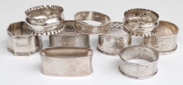 Eight various hallmarked silver napkin rings, weight 142g and a white metal napkin ring marked 800,