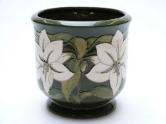 Moorcroft jardiniere decorated with lilies on a green ground, signed to base,
