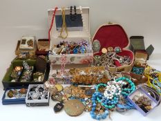 A large collection of costume jewellery including brooches, beads,