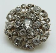 A Victorian silver and gold brooch set with old and rose cut diamonds, the largest approximately 0.
