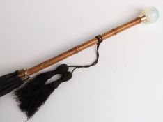 A 19thC/20thC parasol with spherical vaseline glass handle, yellow metal collar,