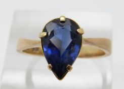 A 9ct gold ring set with a pear cut synthetic sapphire, size R, 4.