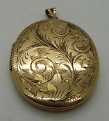 A large 9ct gold locket with engraved detail, 4 x 5cm, 17.