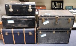 Five vintage travelling trunks including a large ash bound steamer trunk,
