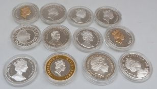 Silver Royal Commemorative crown sized coins in capsules,