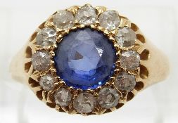 Edwardian 18ct gold ring set with a round cut sapphire surrounded by old cut diamonds,