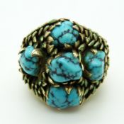 A 14k gold ring set with five turquoise cabochons surrounded by green enamelled leaves, size Q, 22.