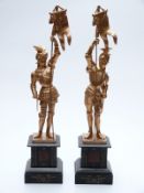 Pair of gilt metal figures of knights holding standards,