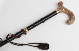 A late 19thC/20thC parasol with yellow metal crook handle,