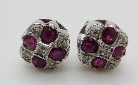 A pair of 9ct white gold earrings set with rubies and diamonds, 1.