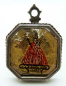 A white metal reliquary pendant with gilt and figural decoration, 3.8 x 5.
