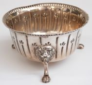 George V hallmarked silver sugar bowl with embossed decoration raised on three lion's mask and paw