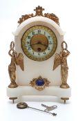 A 19thC alabaster cased clock flanked by semi clad winged figures holding laurel wreaths with blue