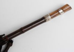 A 19thC/20thC parasol with horn handle, white metal mounts including an oak leaf,