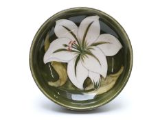 Moorcroft pedestal dish decorated with lilies on a green ground, diameter 11.