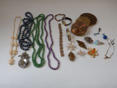 A collection of costume jewellery including agate beads, Art Deco necklaces, compacts, brooches,