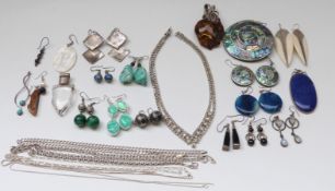 A silver pendant set with lapis lazuli, silver pendant set with pressed amber, silver earrings,