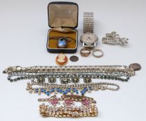 A silver necklace set with butterfly wing, silver locket, diamanté necklaces,