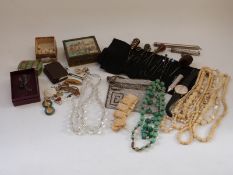 A collection of costume jewellery including a Victorian banded agate hat pin, jadeite pendants,