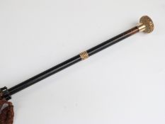 A late 19thC/20thC parasol with 18ct gold plated handle and collar on ebonised stick,