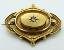Victorian brooch set with a diamond to the centre with applied rope decoration and sphere design,