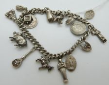 A silver charm bracelet set with 15 charms including donkey, pig, owl,