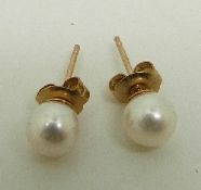 A pair of 9ct gold earrings set with a pearl to each