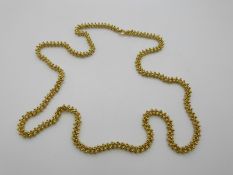 An 18ct gold necklace of knot and sphere links, 107.