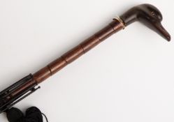Late 19thC/20thC parasol with carved figural duck handle, yellow metal collar and bamboo stick,