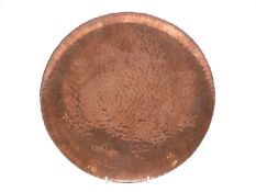 An Arts and Crafts hammered and footed shallow dish, marked West Berlin to base,