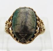 A 19thC yellow metal Egyptian ring set with a ceramic scarab beetle,