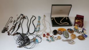 A collection of costume jewellery including brooches, terrier brooch,